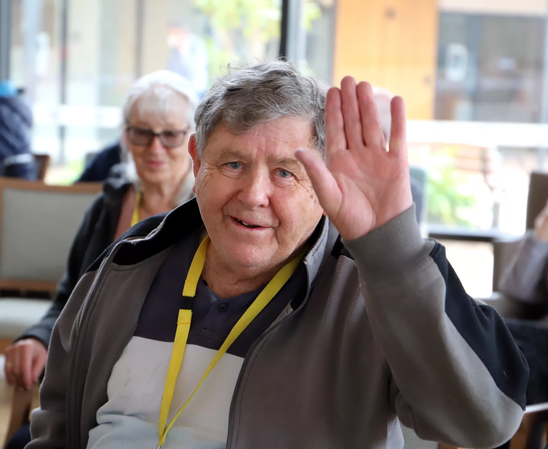 Man waving and women in background at Korongee