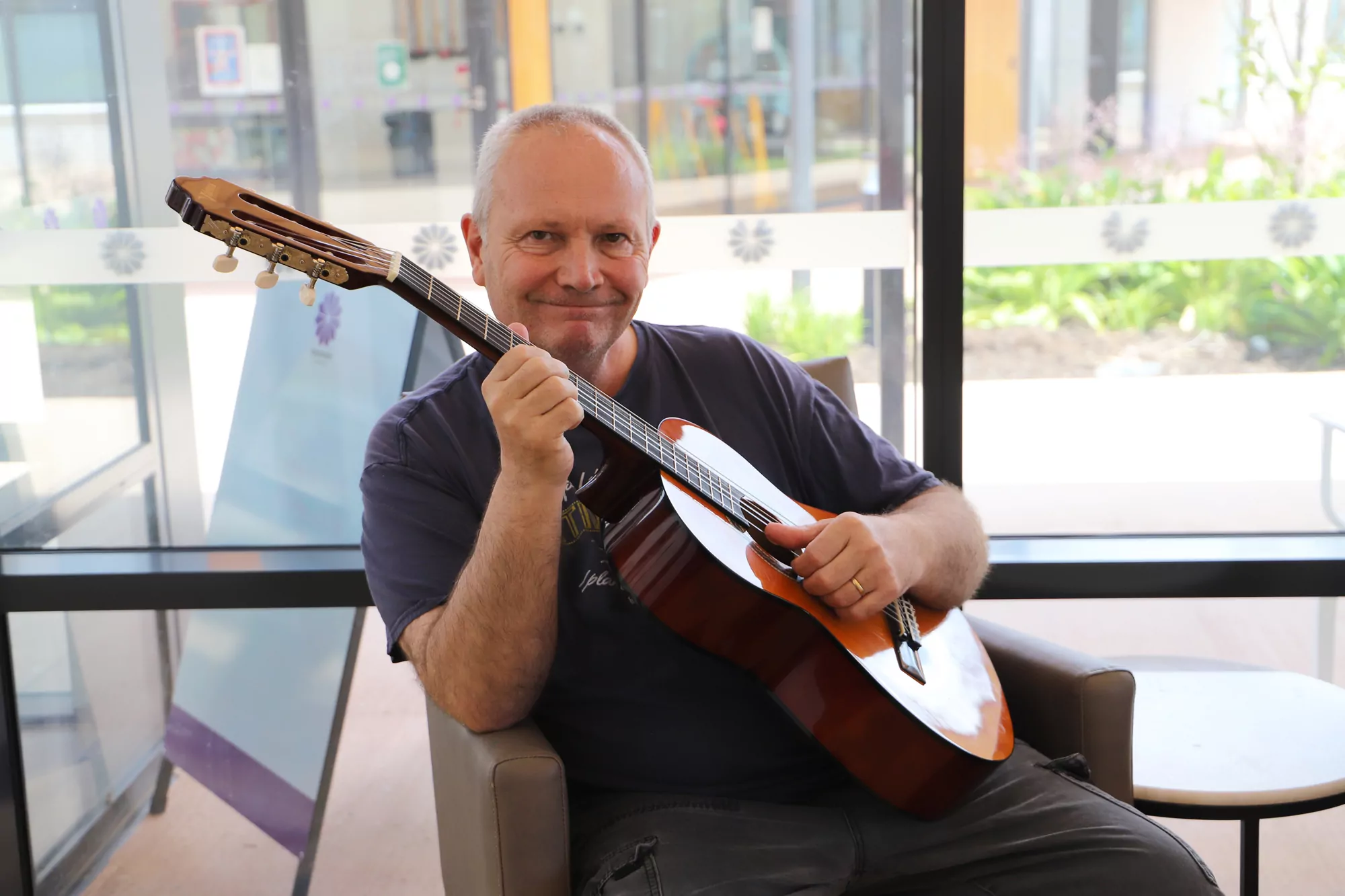 A man playing an acoustic guitar